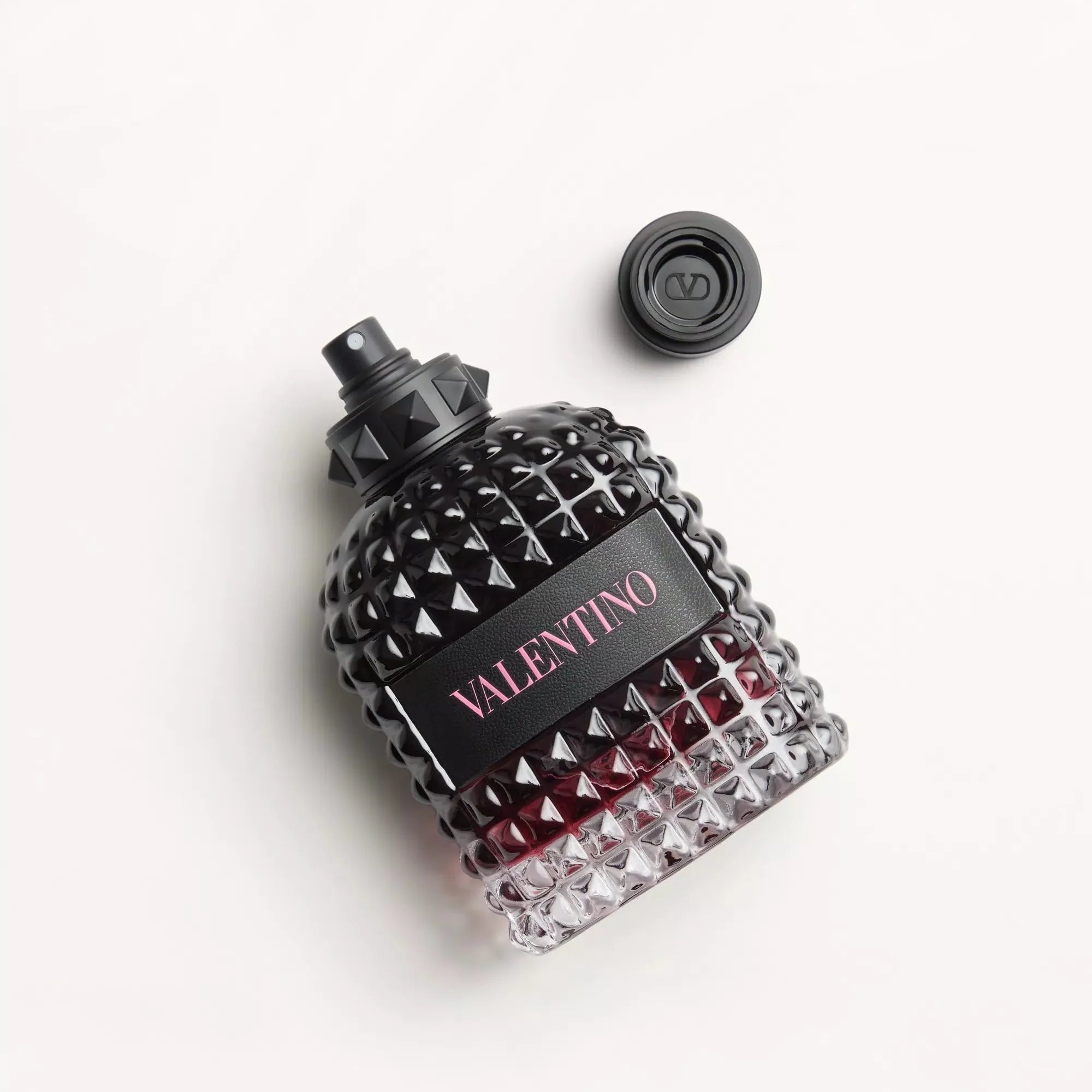 Valentino perfume bottle with black and red design on a white background